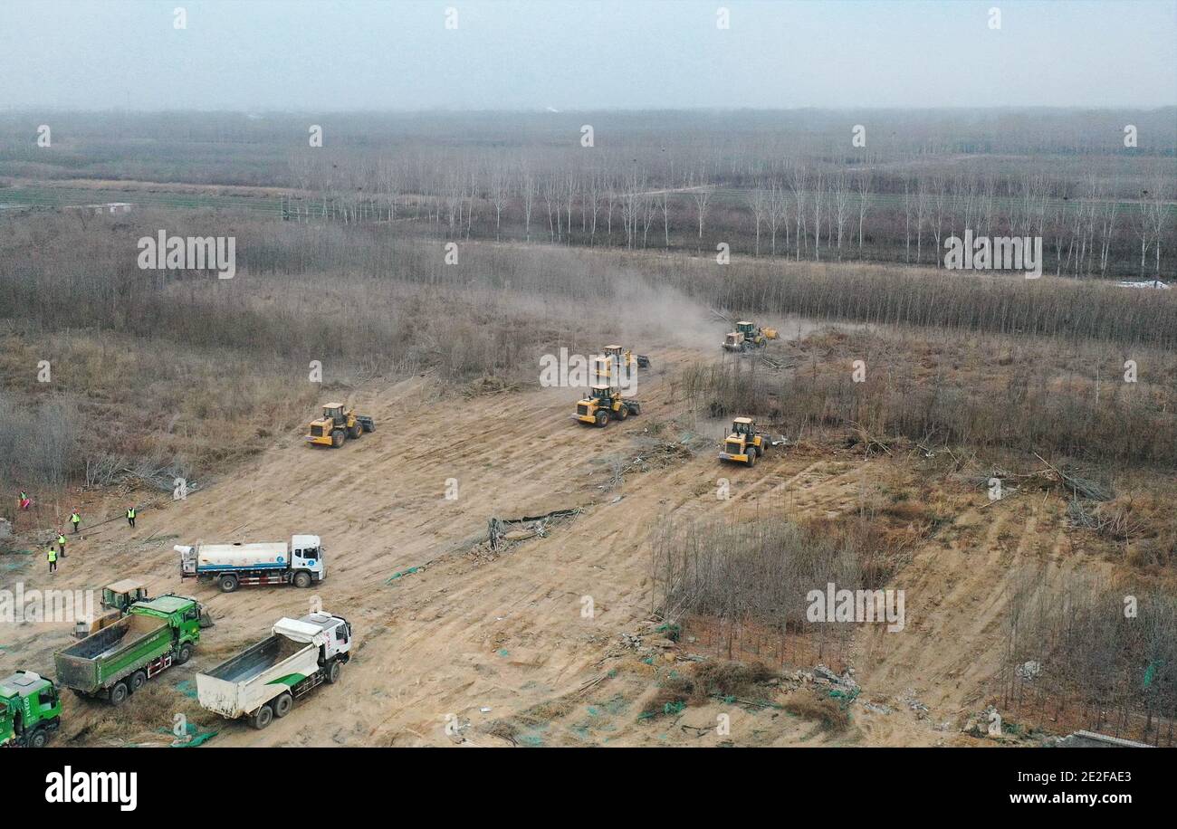 Beijing, China. 13th Jan, 2021. Aerial photo taken on Jan. 13, 2021 shows the construction site of a centralized medical observation center in Shijiazhuang, capital of north China's Hebei Province, where clustered COVID-19 cases occurred. The isolation center will likely cover 33 hectares of area near a village in Zhengding County, Shijiazhuang.Three integrated housing producers in Tangshan City, Hebei, have been entrusted to produce 3,000 makeshift wards for the center. Each ward has a space of 18 square meters. Credit: Yang Shiyao/Xinhua/Alamy Live News Stock Photo