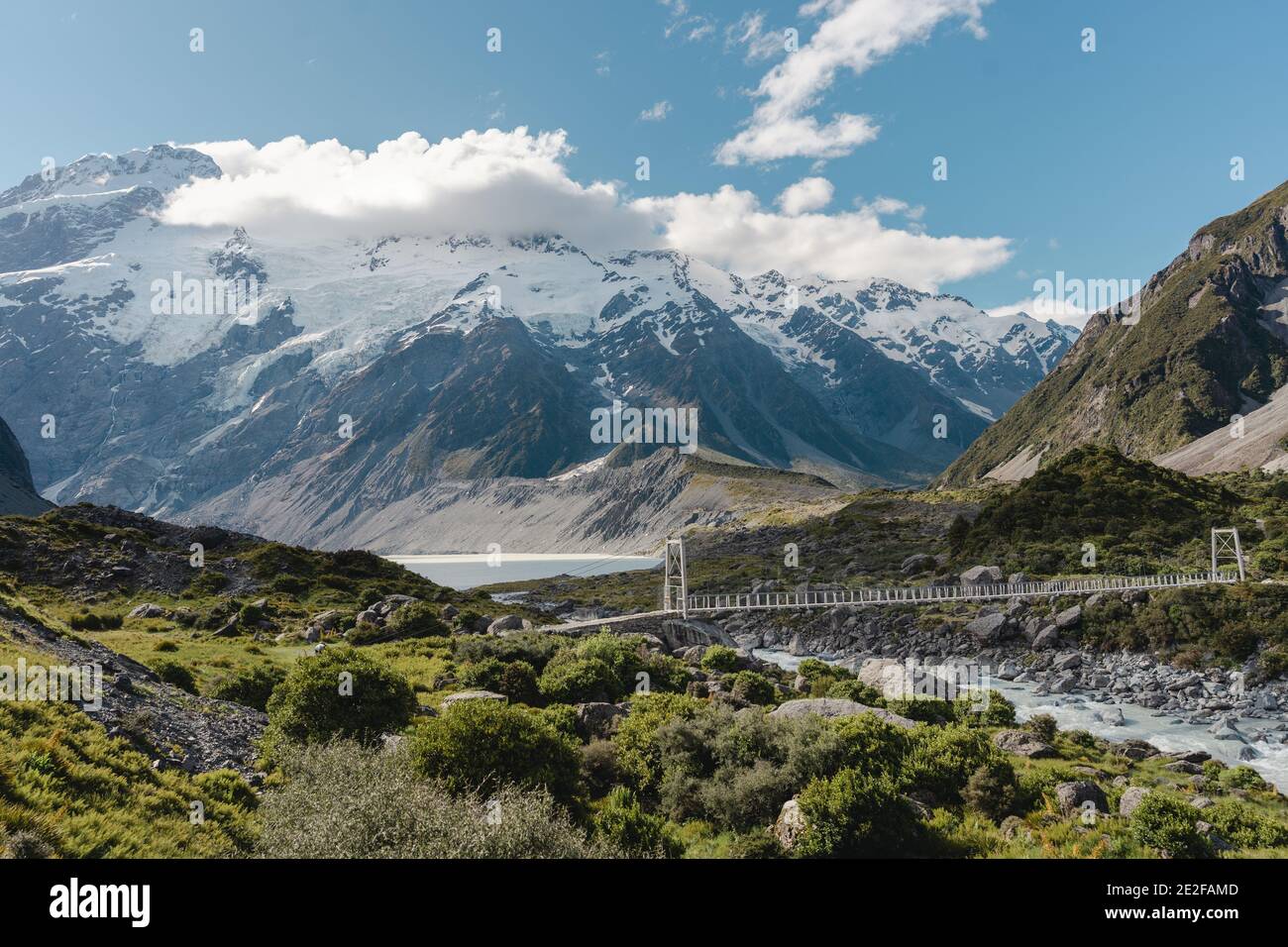 Hooker Valley Track with amazing landscape view of Mueller Lake and suspension Bridge. Mount Cook National Park. New Zealand Stock Photo