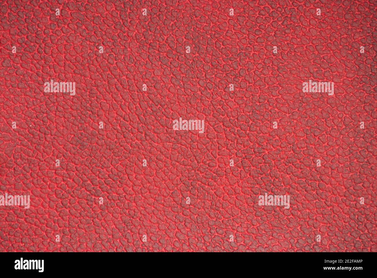 Dark-burgundy genuine leather with a characteristic pattern. Background, pattern, texture. Stock Photo