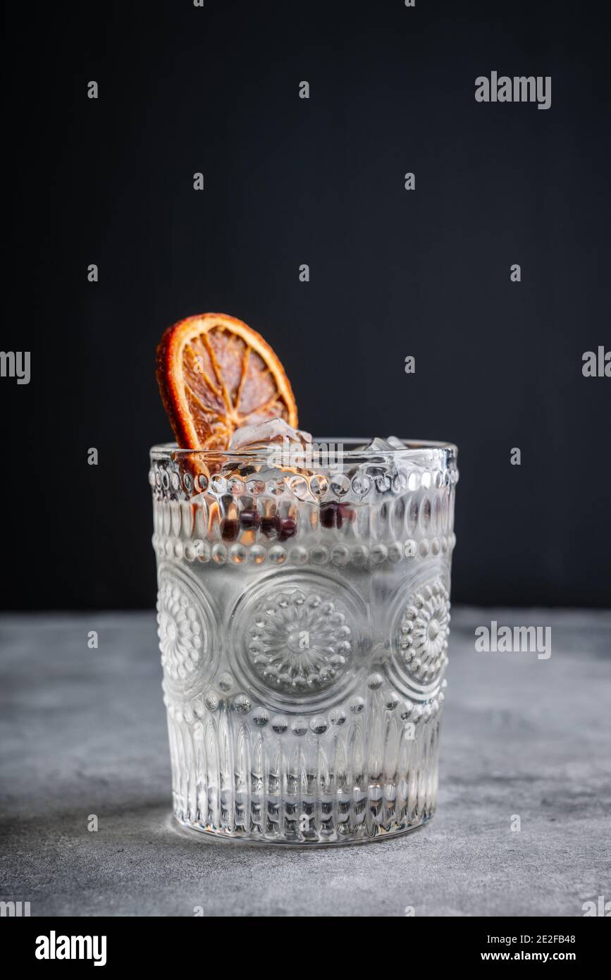Old fashioned gin based cocktail with triple sec on the rustic background. Selective focus. Shallow depth of field. Stock Photo