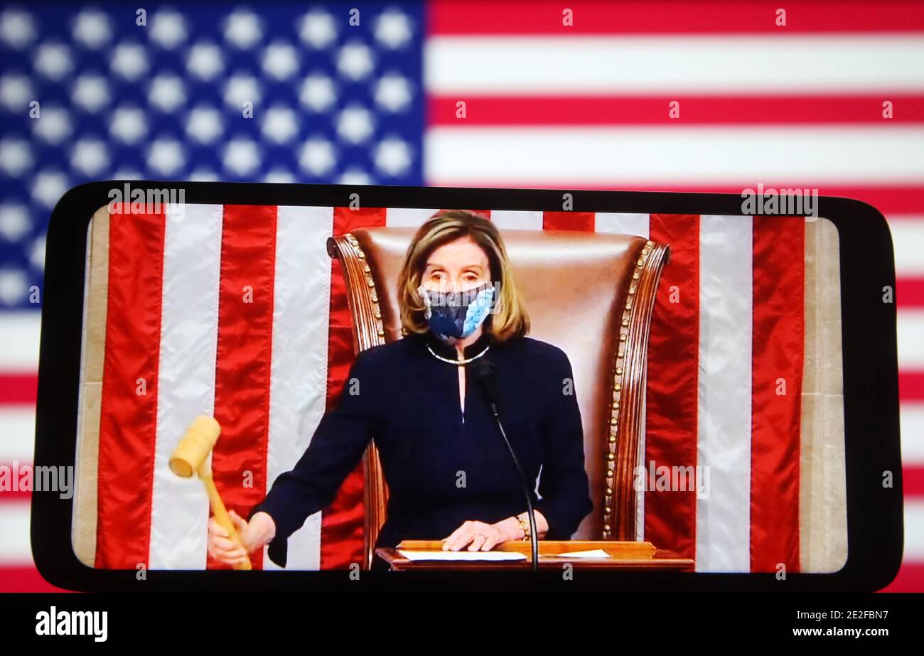 Ukraine. 14th Jan, 2021. In this photo illustration, U.S. Speaker of the House of Representatives Nancy Pelosi is seen during the vote to impeach U.S. President Donald Trump on this frame from a video displayed on a smartphone screen in front the US flag. Credit: Pavlo Gonchar/SOPA Images/ZUMA Wire/Alamy Live News Stock Photo
