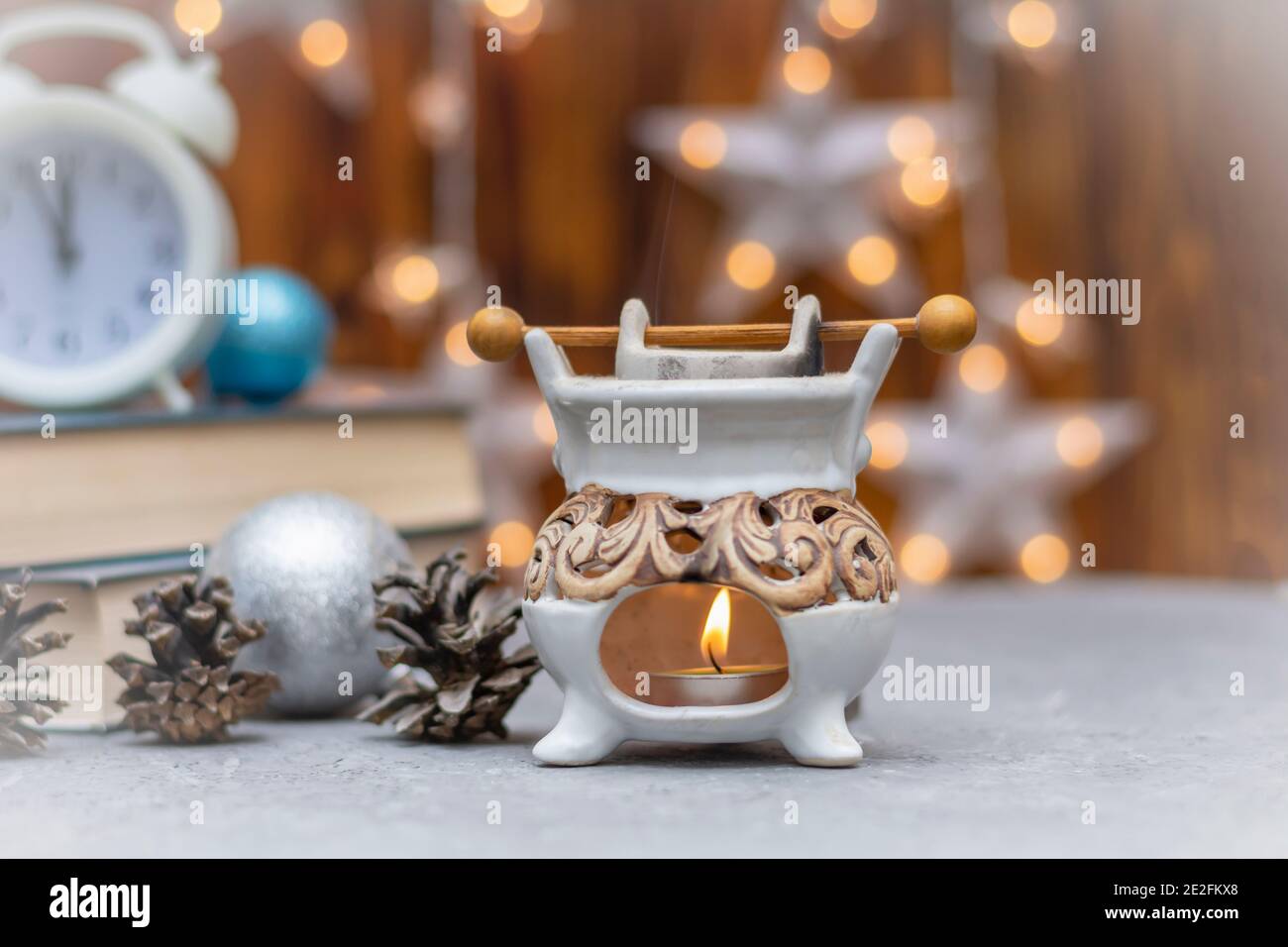 Aromatic lamp for essential oil in winter composition. Close-up, selective focus, fog view. Stock Photo