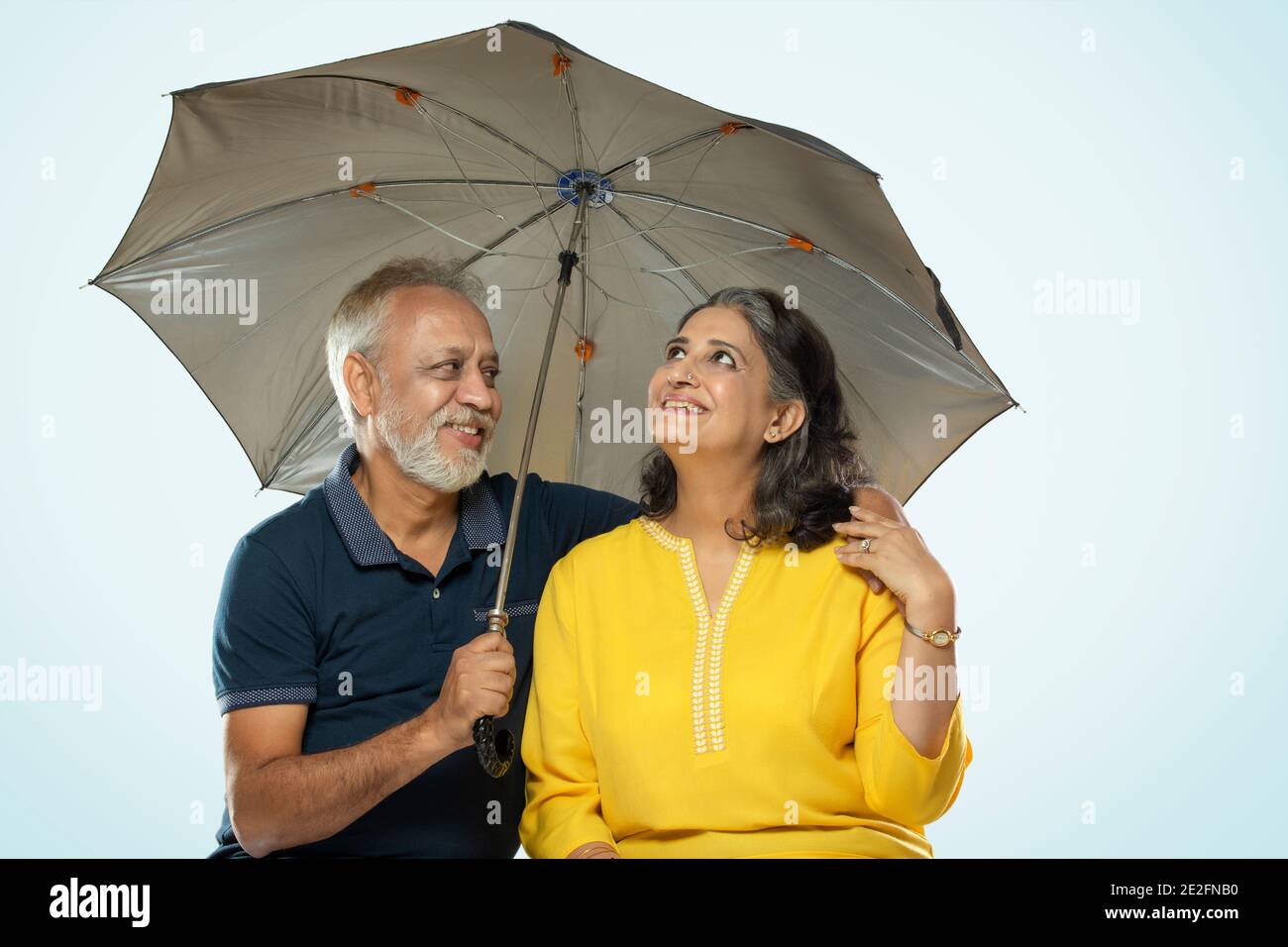 Man under blue umbrella hi-res stock photography and images - Alamy