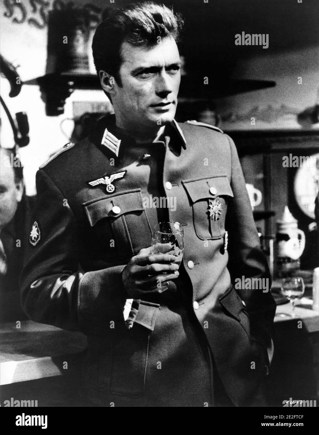 CLINT EASTWOOD in Nazi Uniform at Bar in WHERE EAGLES DARE 1968 director BRIAN G. HUTTON story / screenplay Alistair MacLean music Ron Goodwin producers Elliot Kastner and Jerry Gershwin  Gershwin-Kastner Productions / Winkast Film Productions / Metro Goldwyn Mayer Stock Photo