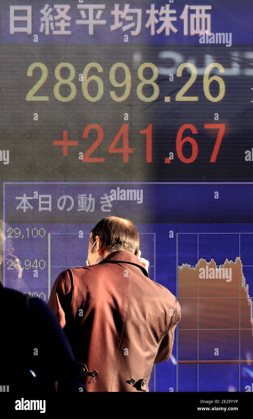 Tokyo, Japan. 14th Jan, 2021. A man watches a share prices board in Tokyo on Thursday, January 14, 2021. Japanese share prices rose 241.67 yen to close at 28,698.26 yen with a new 30-year high at the Tokyo Stock Exchange. Credit: Yoshio Tsunoda/AFLO/Alamy Live News Stock Photo