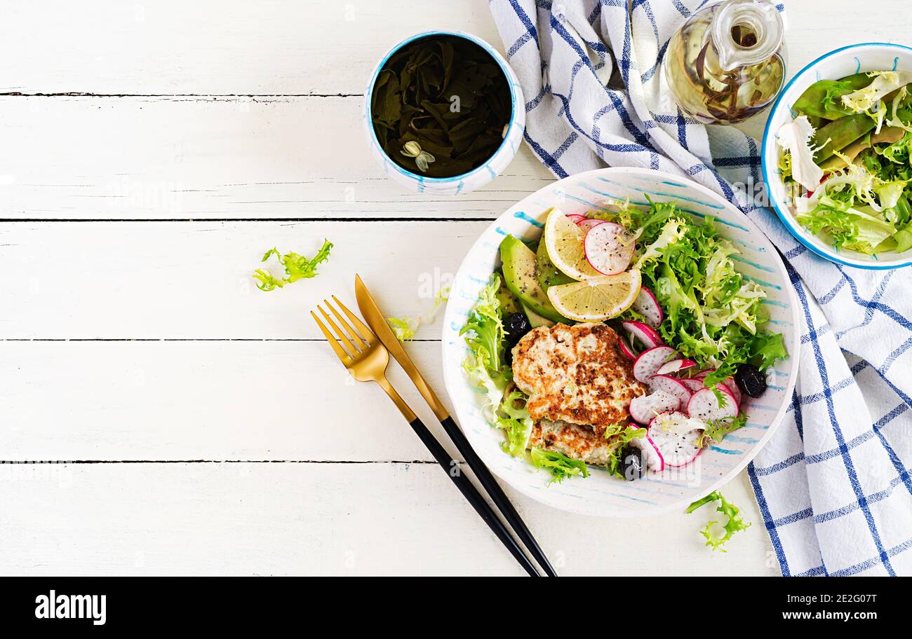 Ketogenic diet. Buddha bowl dish with chicken burger, avocado, radish ...