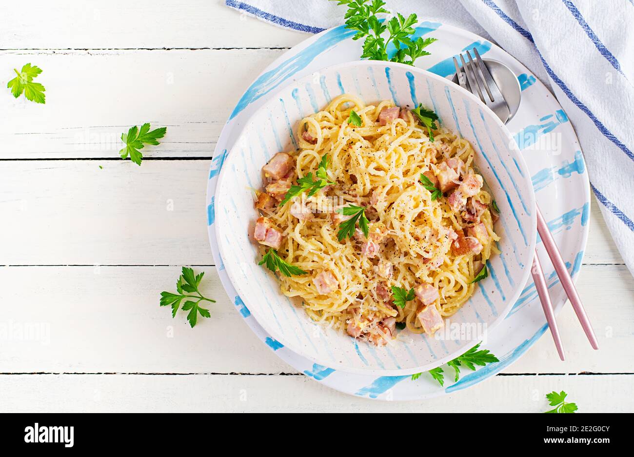 Classic homemade carbonara pasta with pancetta, egg, hard parmesan cheese and cream sauce. Italian cuisine. Spaghetti alla carbonara. Top view, copy s Stock Photo