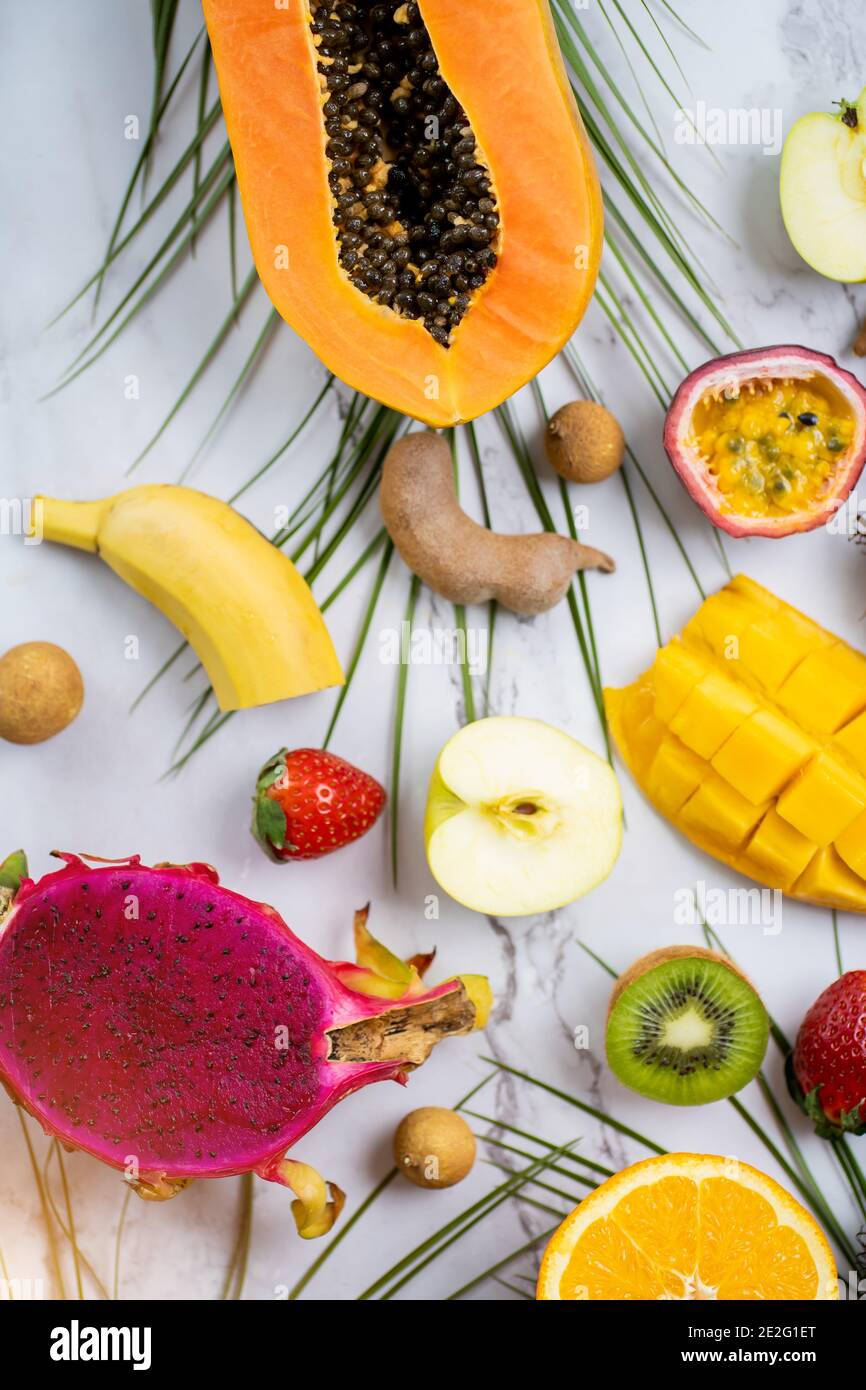 Ripe juicy seasonal tropical fruits. Papaya, kiwi, banana,apple, dragon