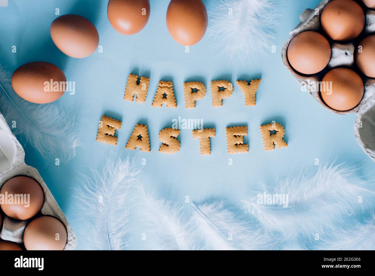 Happy Easter lettering on colored background with eggs Stock Photo