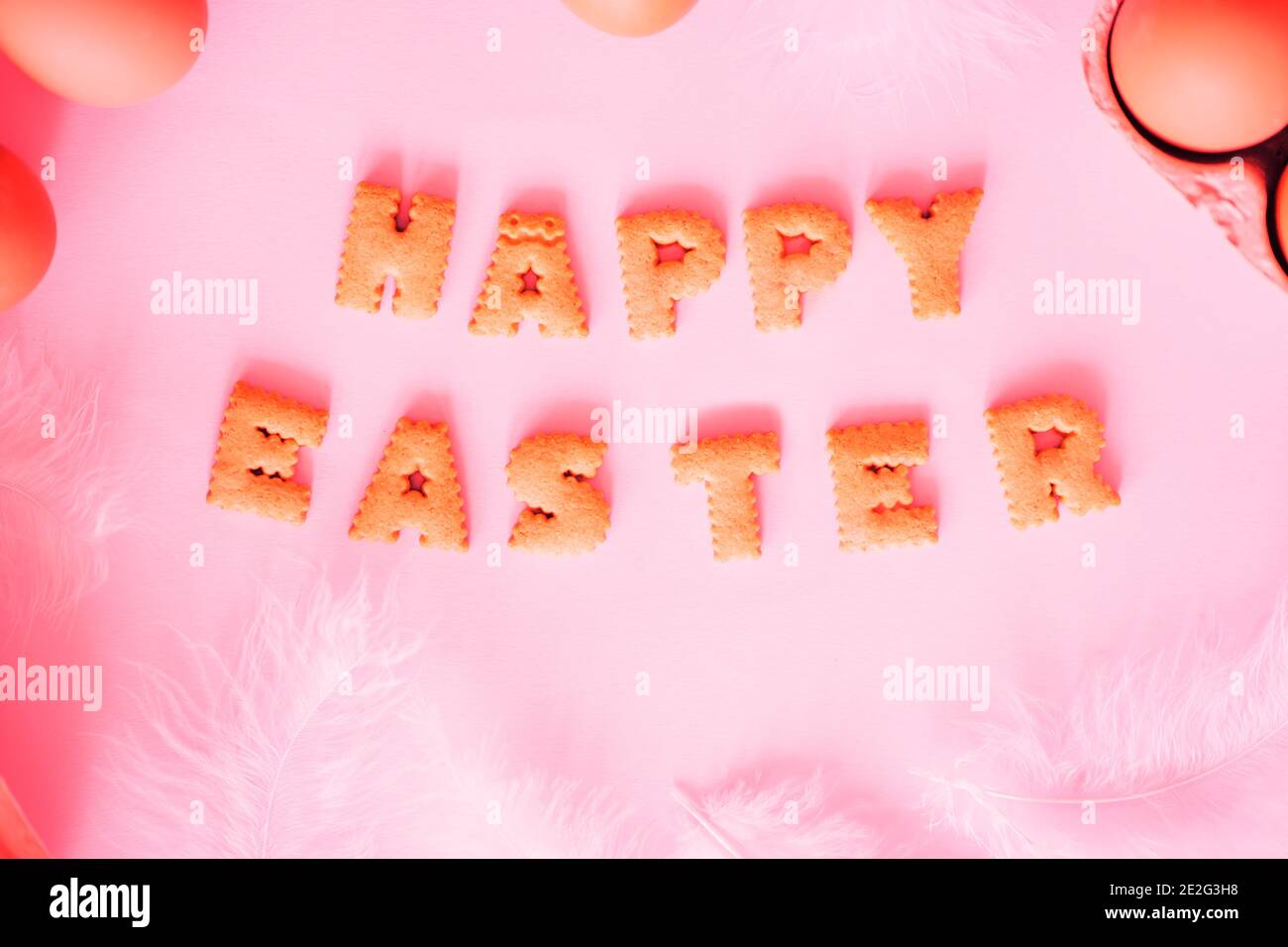 Happy Easter lettering on colored background with eggs Stock Photo