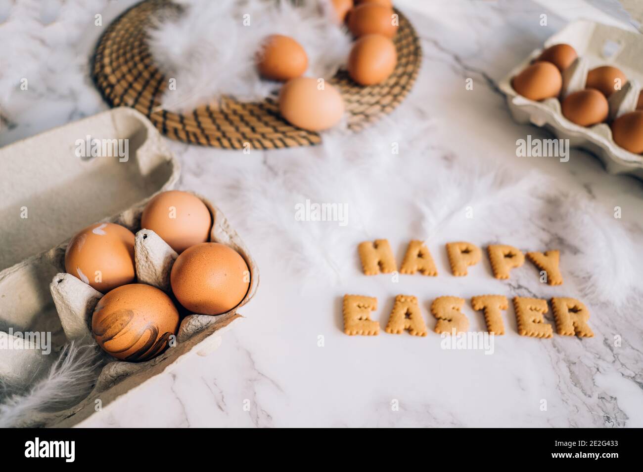 Happy Easter in colourful background. Easter, a table with eggs and the inscription happy Easter Stock Photo