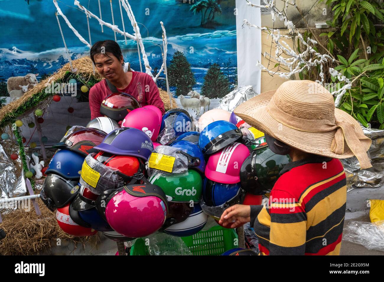 Woman shopping for a motorbike helmet, Phuoc Hoi, Vietnam Stock Photo