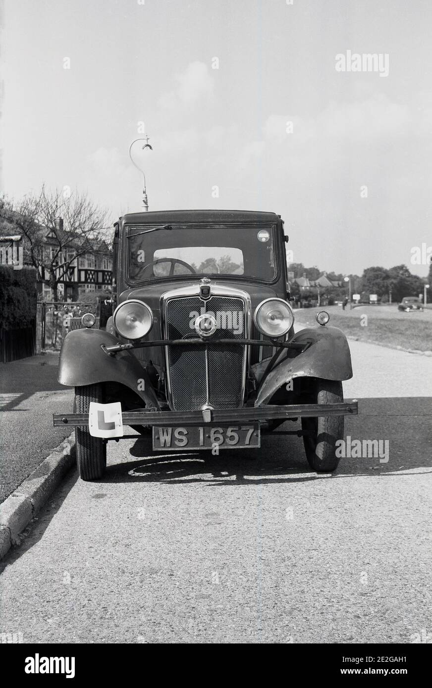 circa l930s, 1940s, historical, a motor car of the era, a Morris Vesker( Ten) parked in a street, England, UK. The Morris Ten was available in a number ff different versions;, saloon, 4-door Tourer and two-seater with a 'dicky' seat.  Morris was a British car manufacturer that started in 1919. The firm's owner, William Morris replicated many of the mass production techiques of the American automobile pioneer, Henry Ford. Morris as a brand name was still in use in the  early 1980s, until the company's owner, British Leyland, dropped the name in 1984. Stock Photo