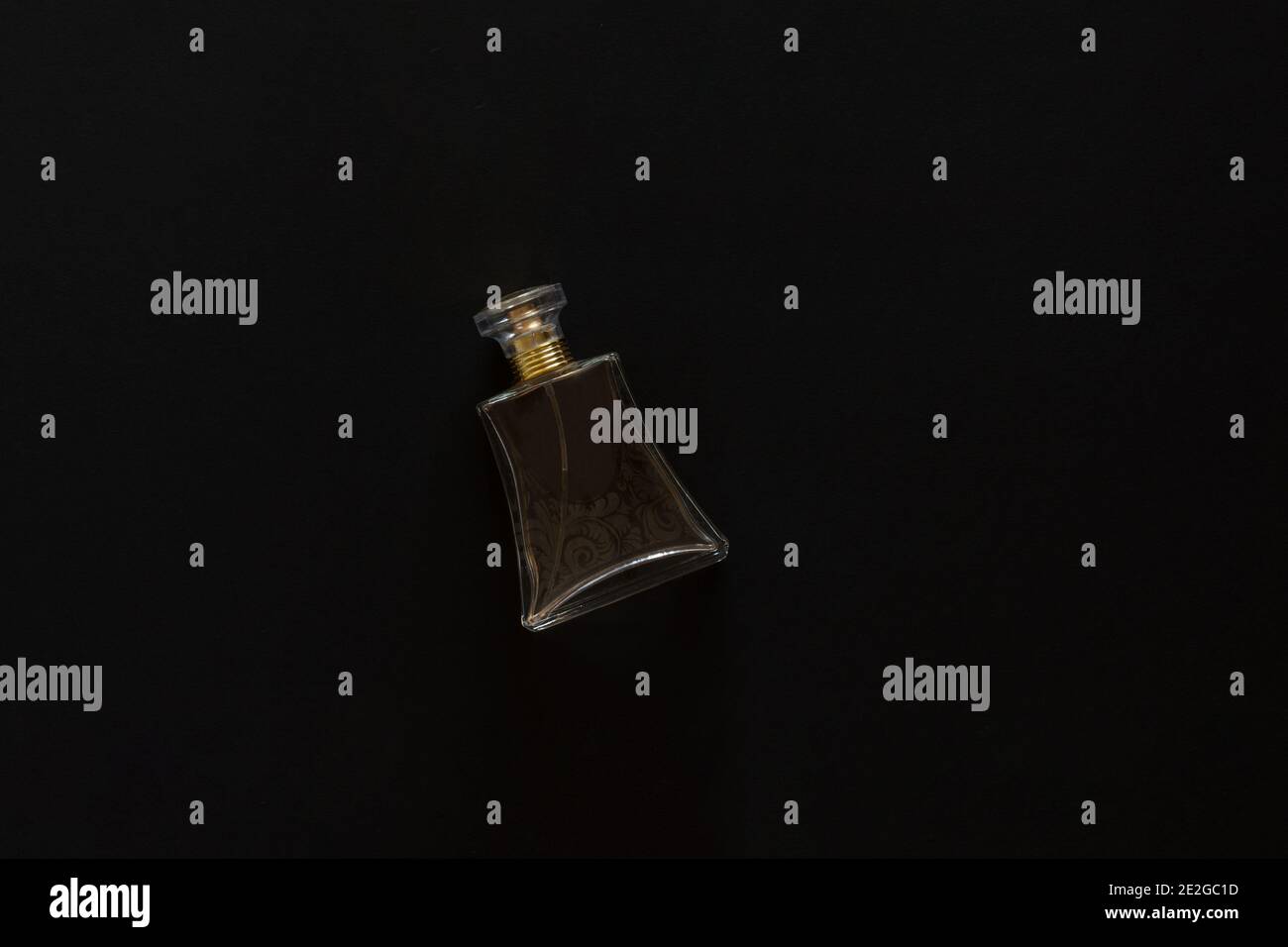 Closeup of a perfume bottle isolated on a black background Stock Photo