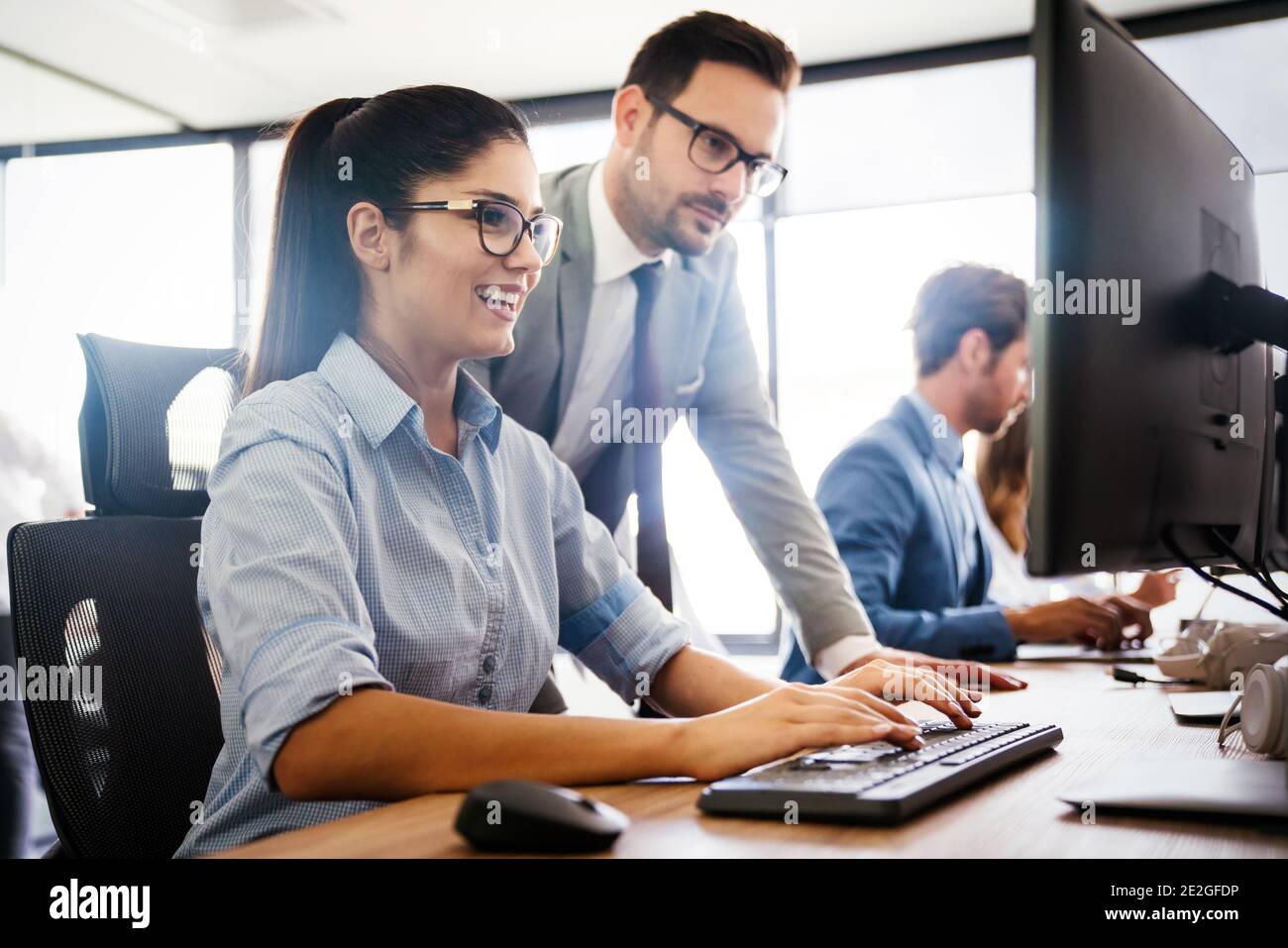 Programmers cooperating at IT company developing apps Stock Photo