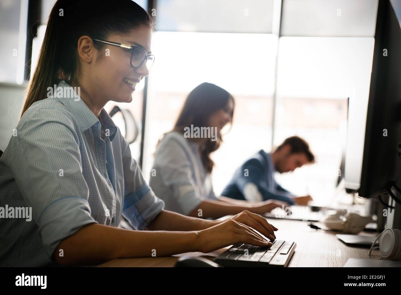 Programmers cooperating at IT company developing apps Stock Photo