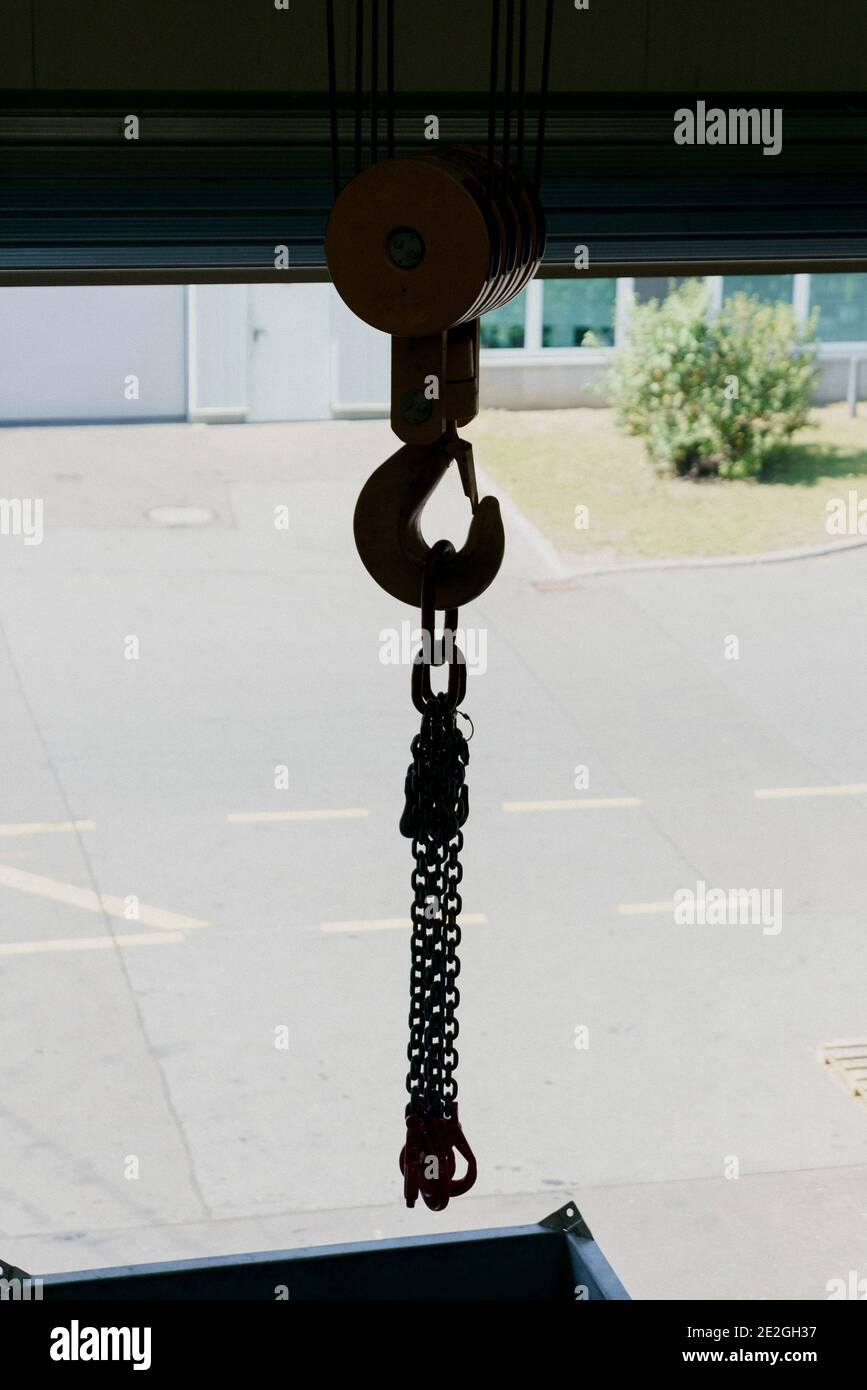 Cable winch hook with chains at loading dock doorway Stock Photo