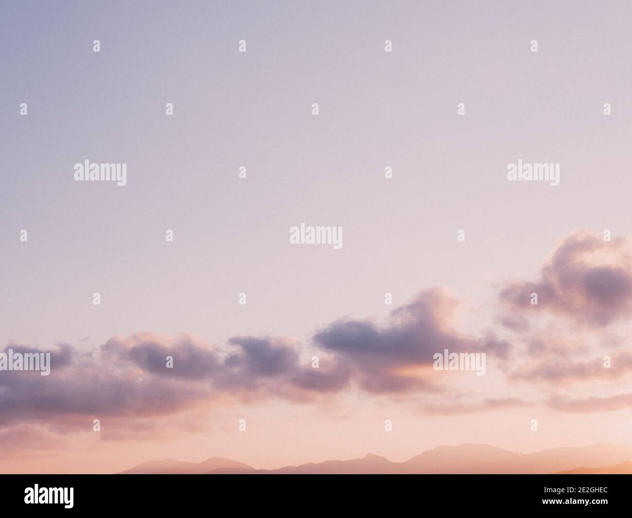 Pale purple and clouds in tranquil sunset sky Stock Photo