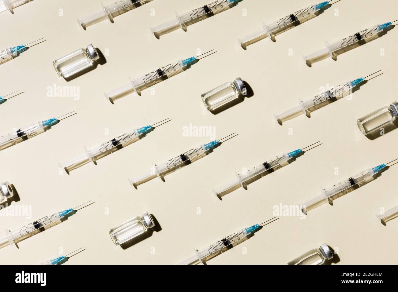 COVID-19 vaccine syringes and vials on yellow background Stock Photo ...