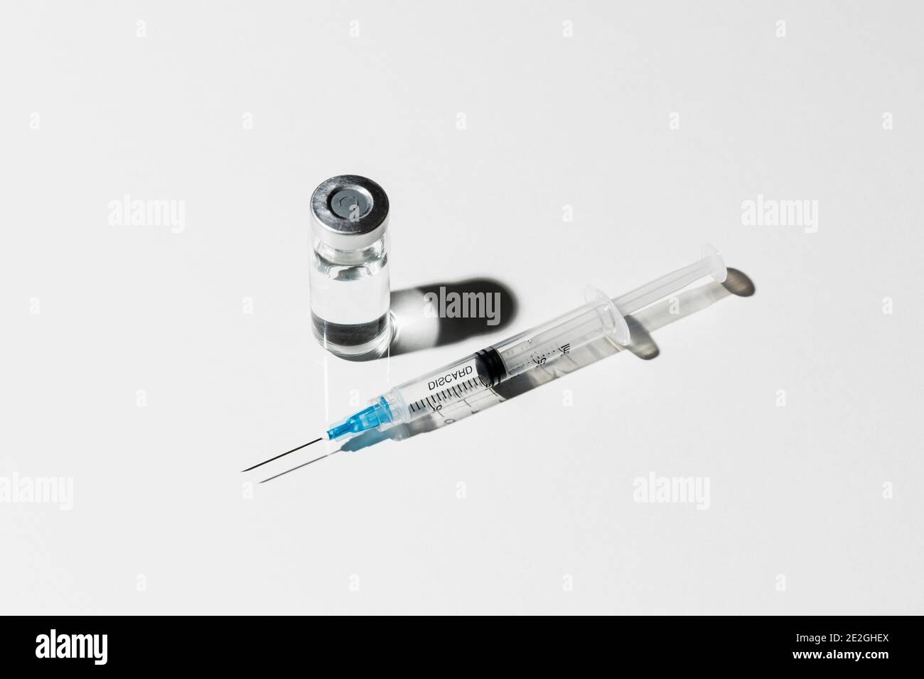 COVID-19 vaccine vial and syringe on white background Stock Photo - Alamy