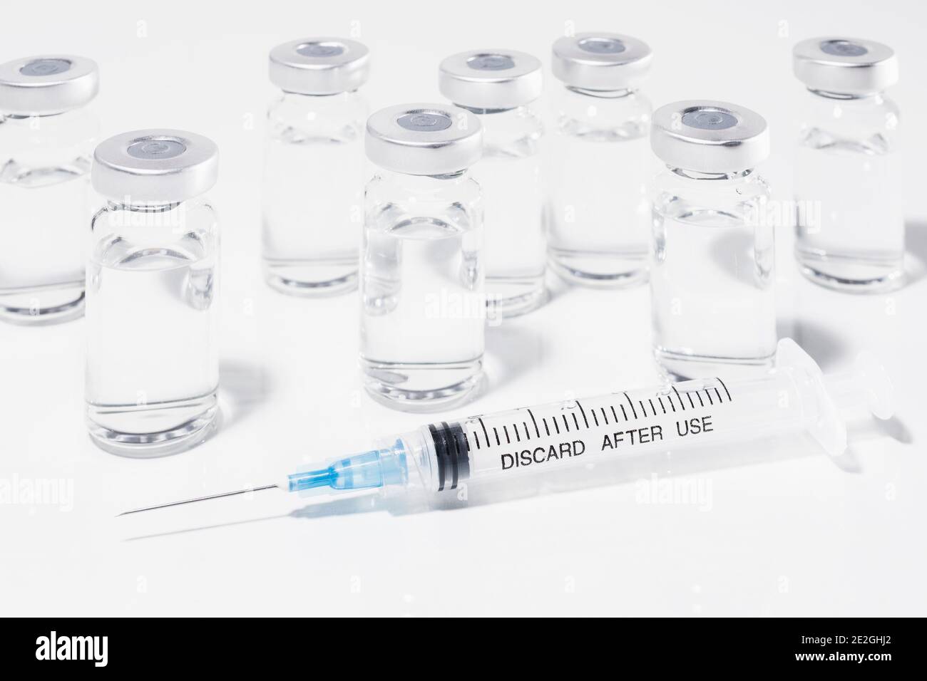 COVID-19 vaccine vials and syringe on white background Stock Photo - Alamy
