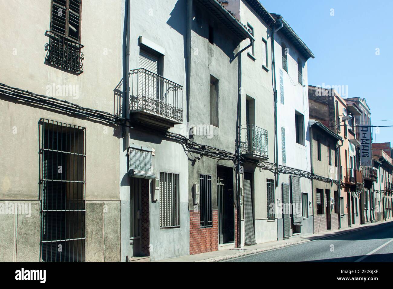 Townhouses on a road going through a classic Spanish town Stock Photo