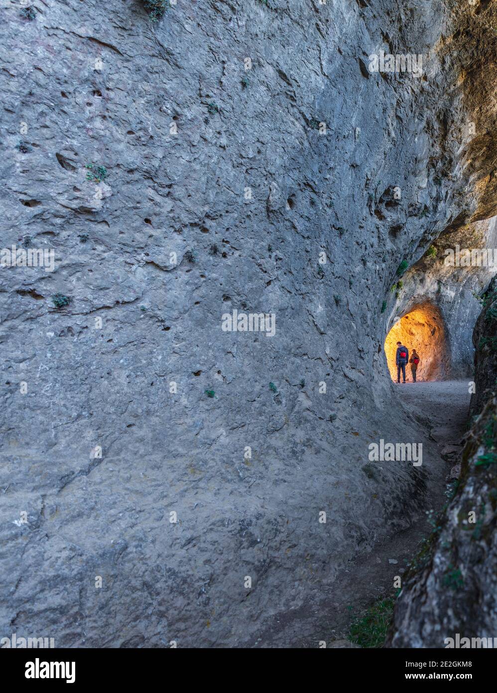 Two unrecognizable persons walking through the tunnel Stock Photo