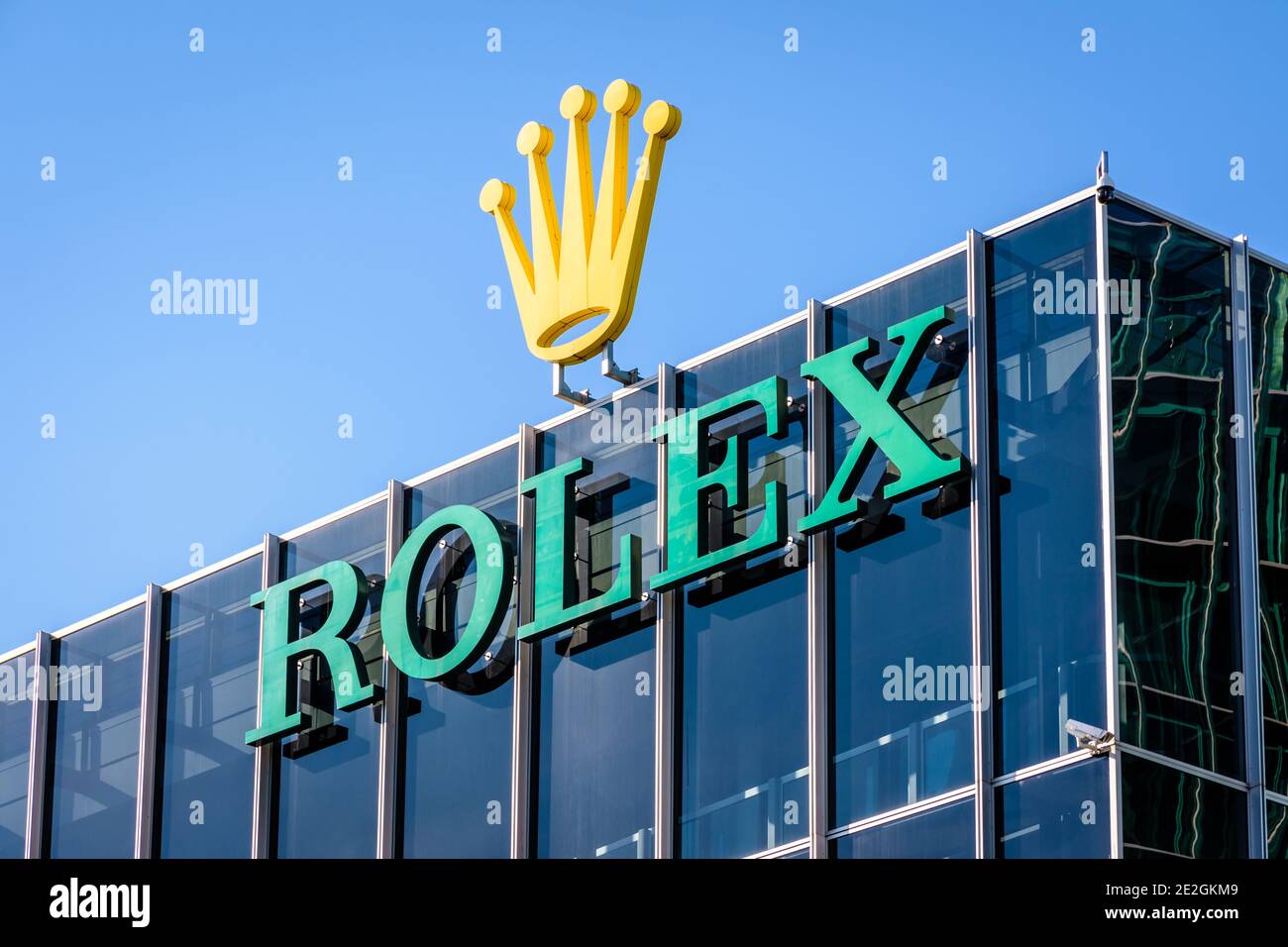 Close-up view of the Rolex logo at the top of a building at the headquarters of the swiss brand of luxury watches in Geneva. Stock Photo