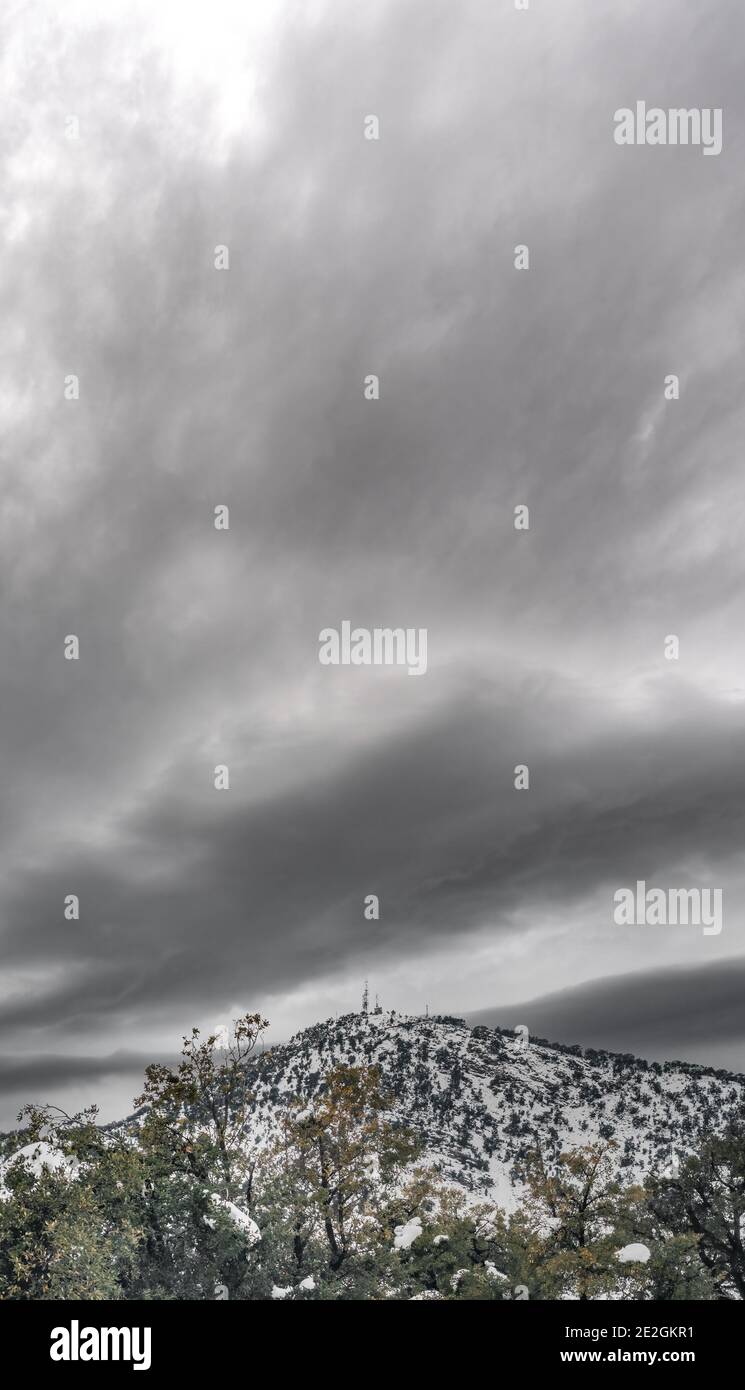 Dark stormy sky over mountain peak with antenna Stock Photo - Alamy