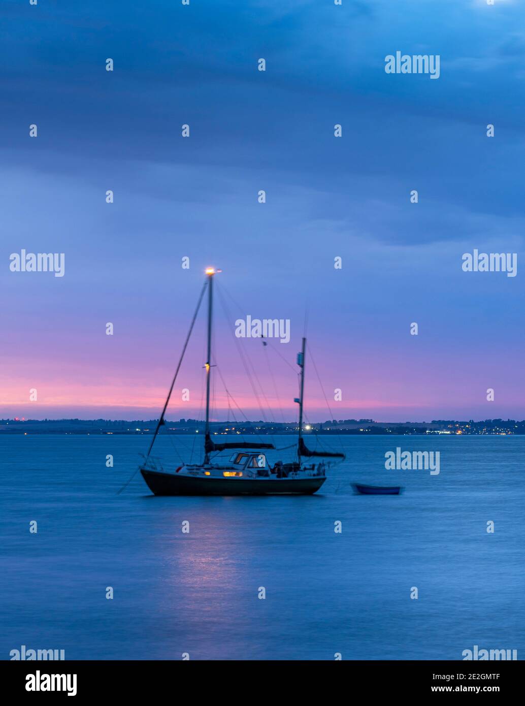 Yacht off the North Kent coast at Whitstable at dusk. Stock Photo