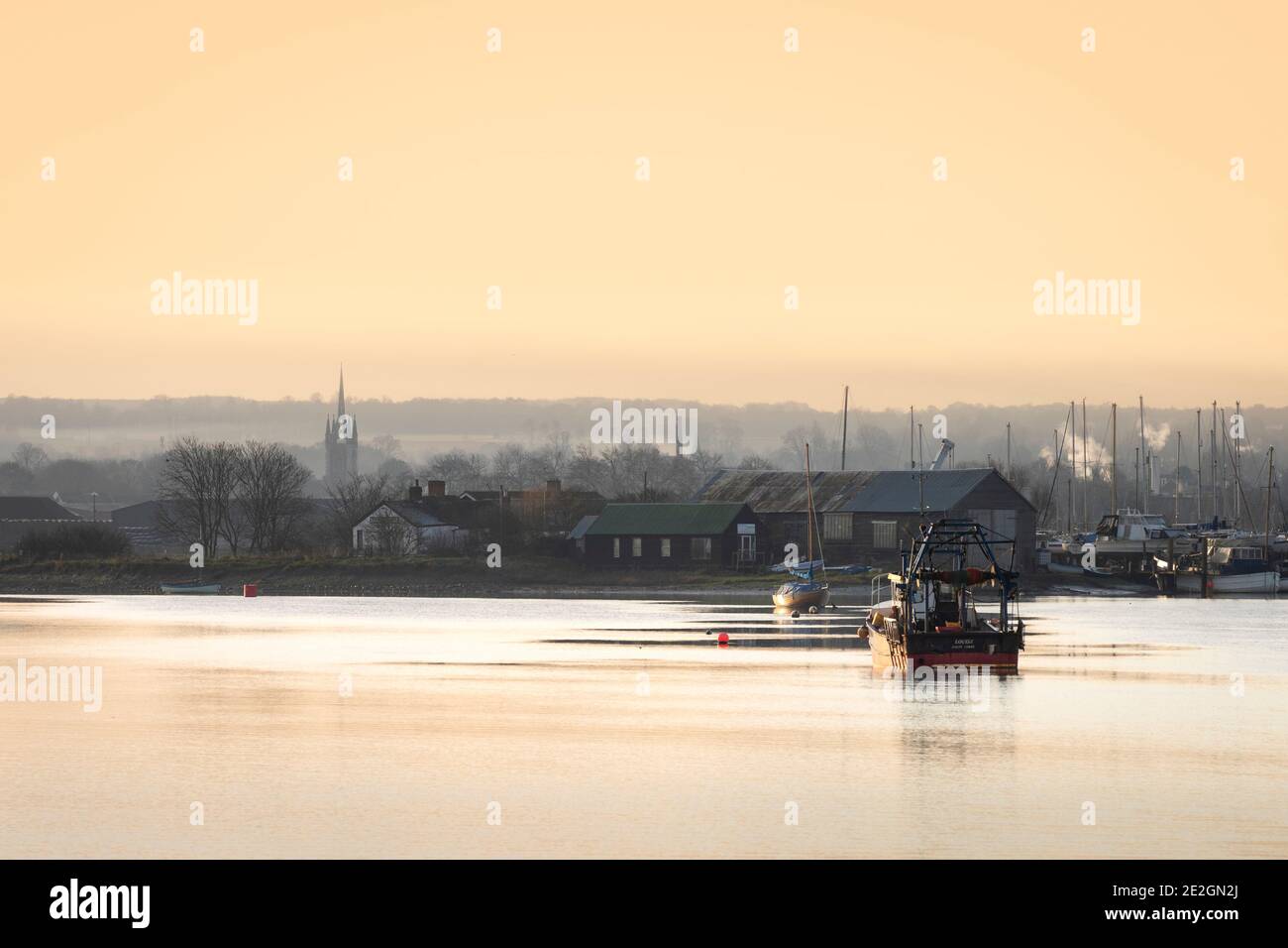 Faversham Creek on the North Kent coast with Faversham's iconic St. Mary of Charity Church in the distance. Stock Photo