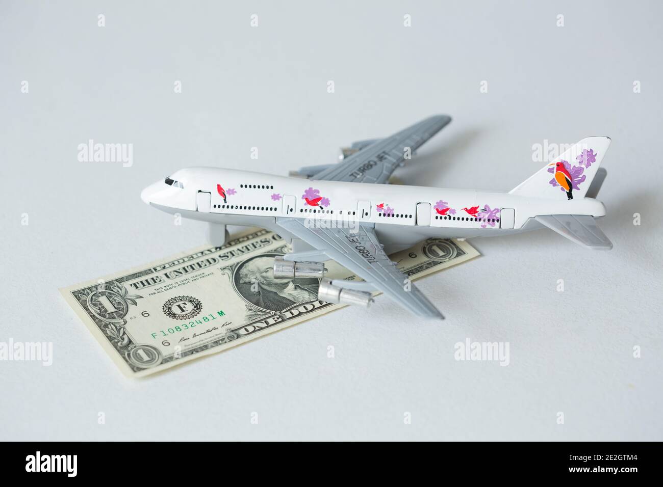 Airplane jet with kazakhstan national currency kzt tenge on the white background Stock Photo