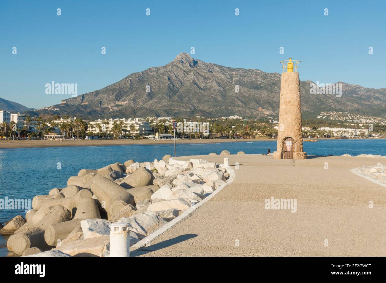 Puerto Banus Pier with beach behind, Marbella, Costa del Sol, Southern Spain,  La Concha mountain, Andalucia, Spain. Stock Photo