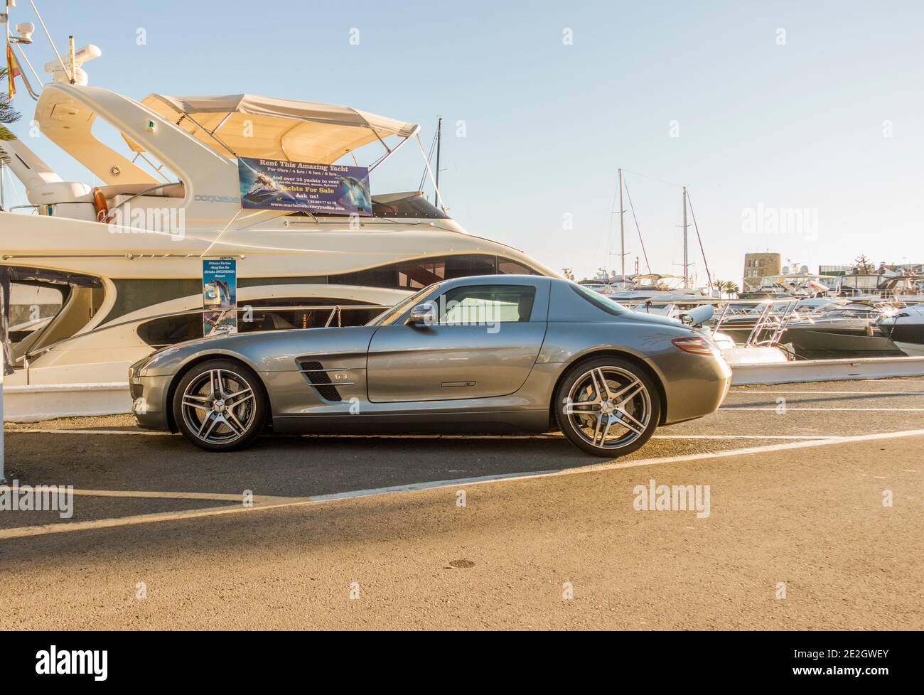 Puerto Banús, with luxury cars parked in port, Yachts behind, Marbella, Nueva Andalucia, Costa del sol, Andalucia, Spain. Stock Photo