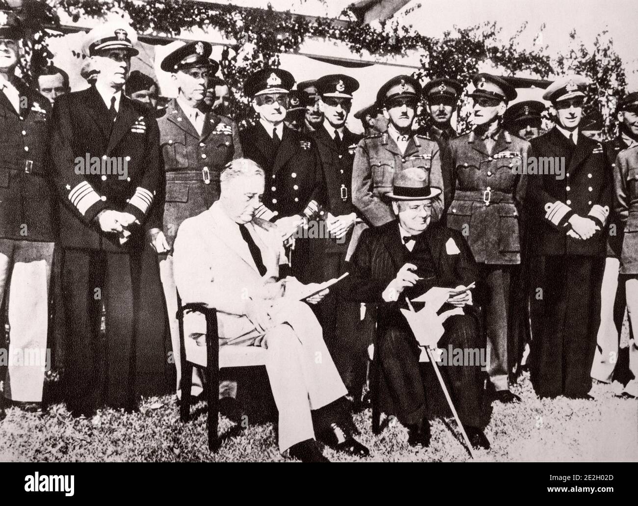 The Casablanca conference. Surrounded by their technical advisers, President Roosevelt and the British Prime Minister discuss the operations of the 19 Stock Photo