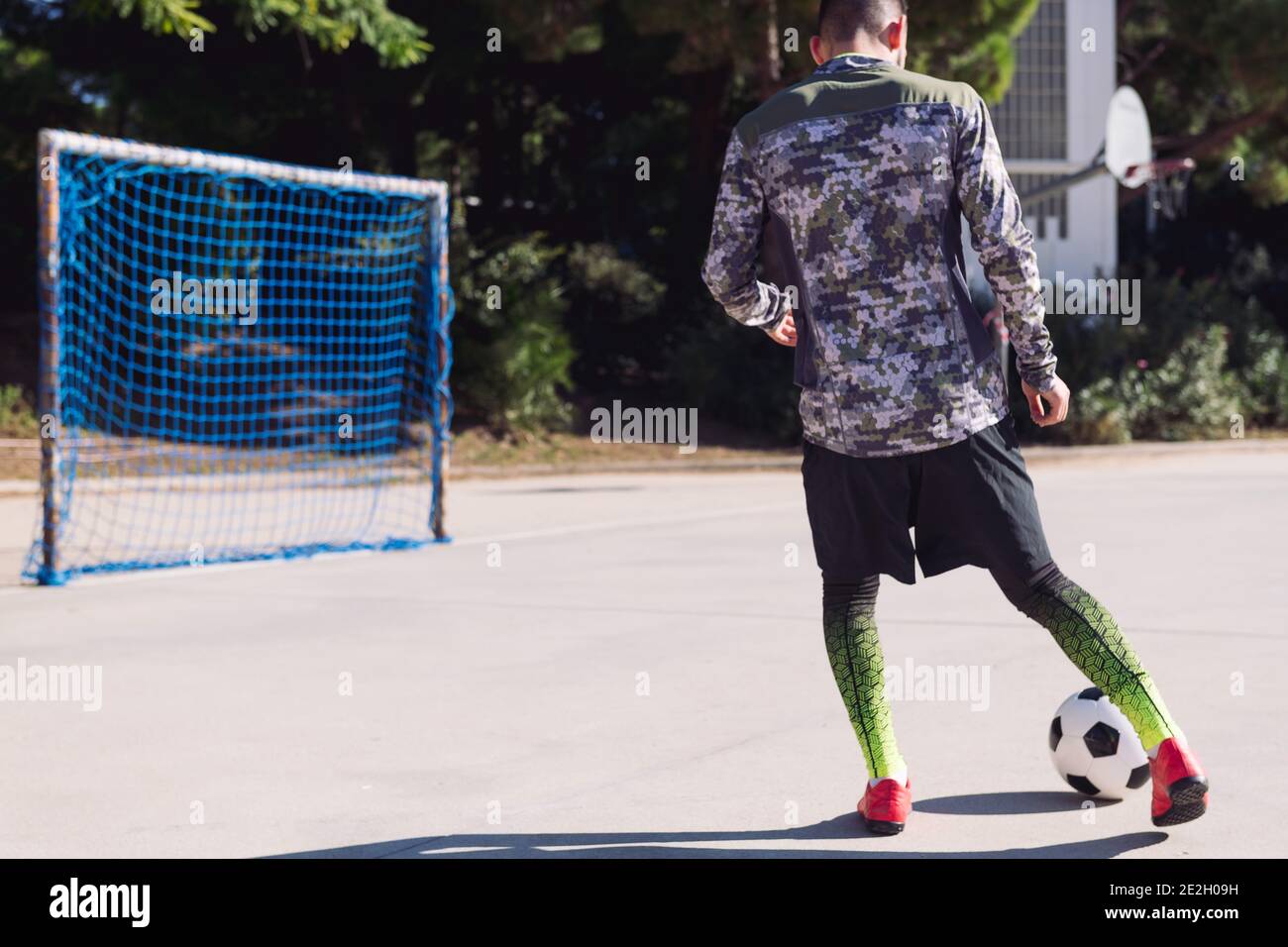 Rear View Of An Unrecognizable Football Player Kicking The Soccer Ball Into An Empty Goal In A Concrete Football Court Concept Of Healthy Lifestyle A Stock Photo Alamy
