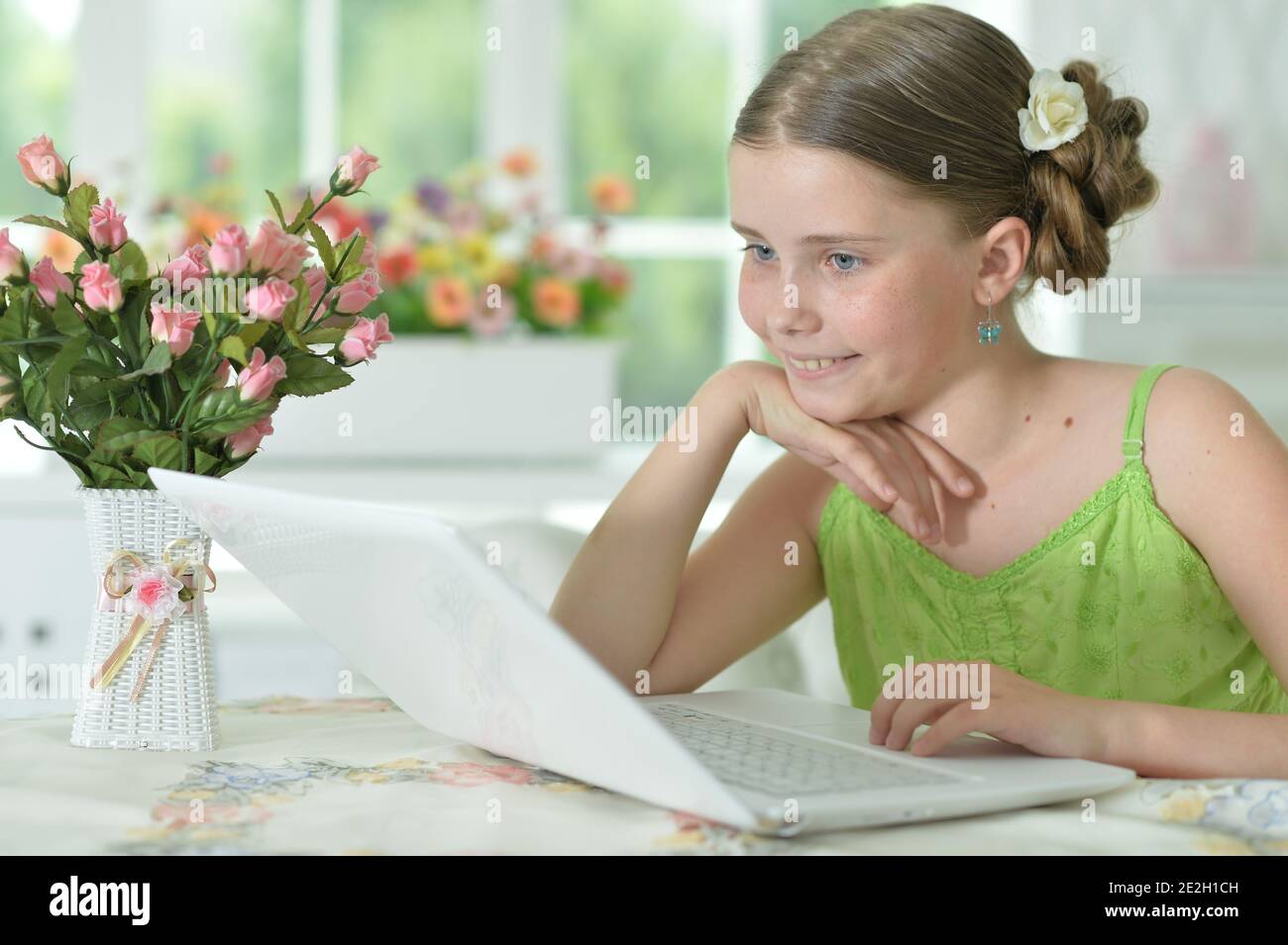 Happy cute girl using laptop at home Stock Photo - Alamy