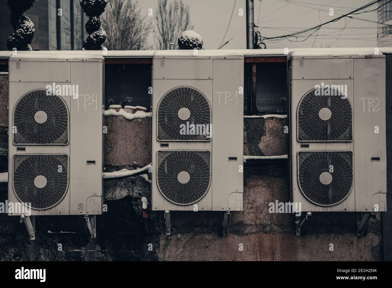 backside of the urban fashion store. dirty old air conditioners on a vintage  wall Stock Photo