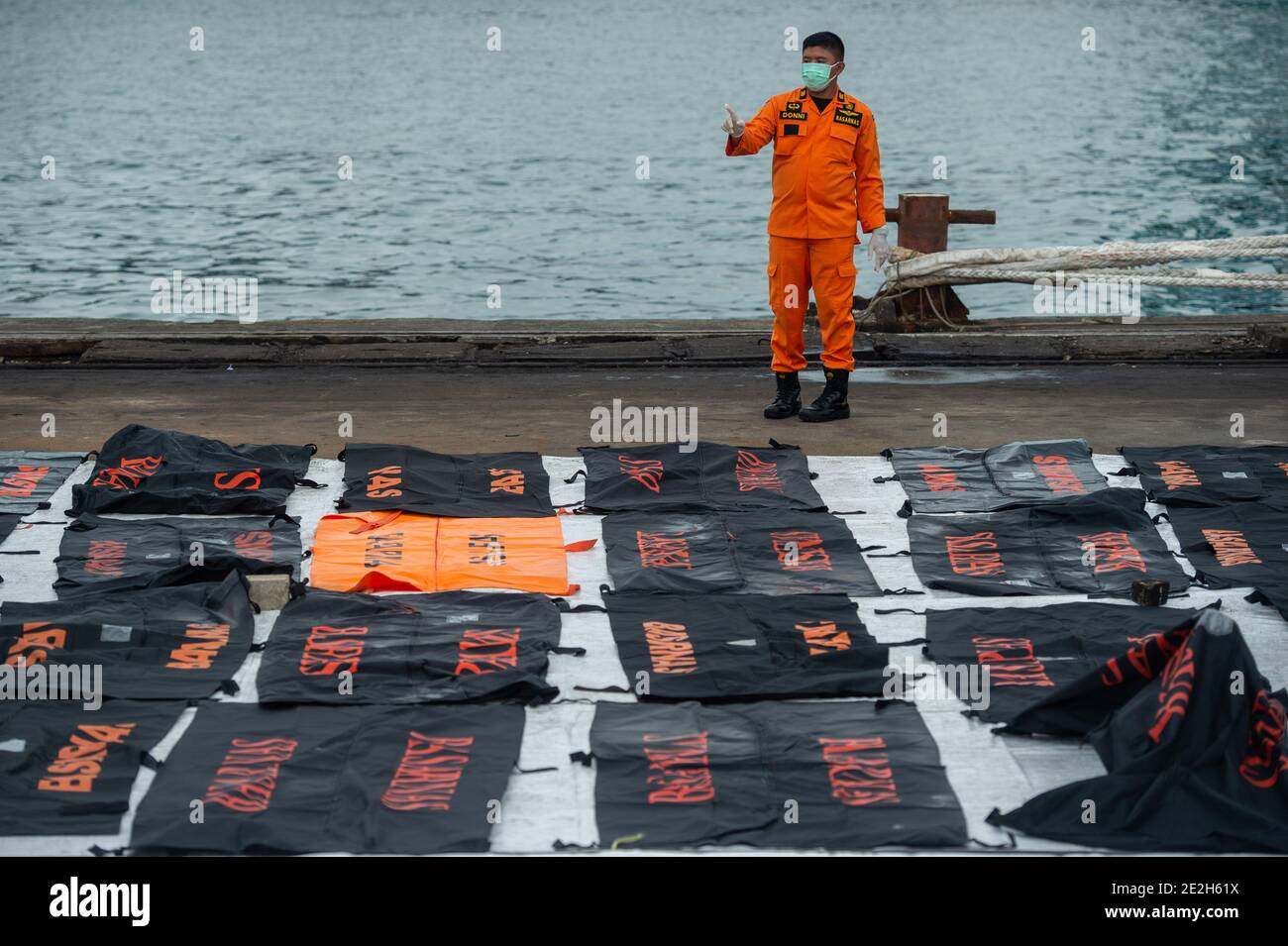 Jakarta, Indonesia. 14th Jan, 2021. A staff member counts bags containing body parts of the victims of the Sriwijaya Air plane crash at the Search and Rescue Command center at Tanjung Priok Port in Jakarta, Indonesia, Jan. 14, 2021. On Jan. 9, a Sriwijaya Air Boeing 737-500 plane with 62 people aboard lost contact minutes after takeoff and crashed into waters off the coast of Indonesia's capital Jakarta. Credit: Veri Sanovri/Xinhua/Alamy Live News Stock Photo