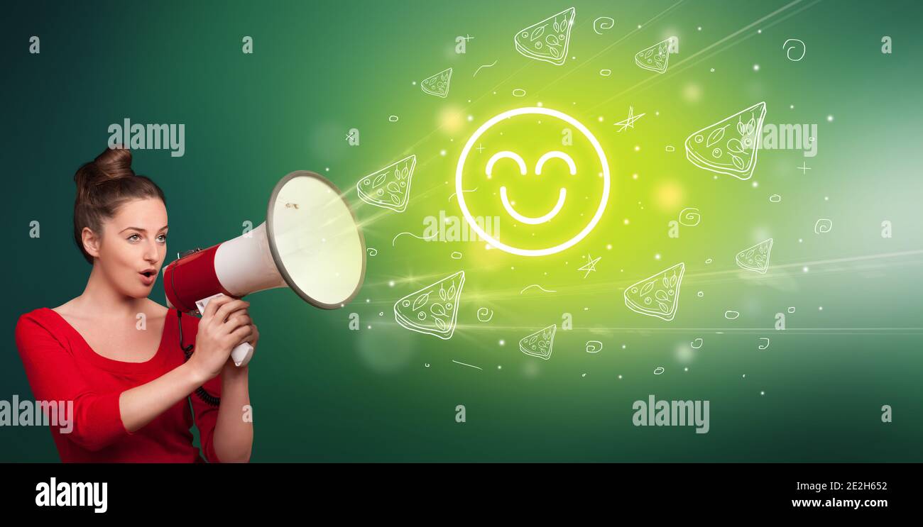 Young person shouting in megaphone and satisfied emoticon icon, healthy eating concept Stock Photo