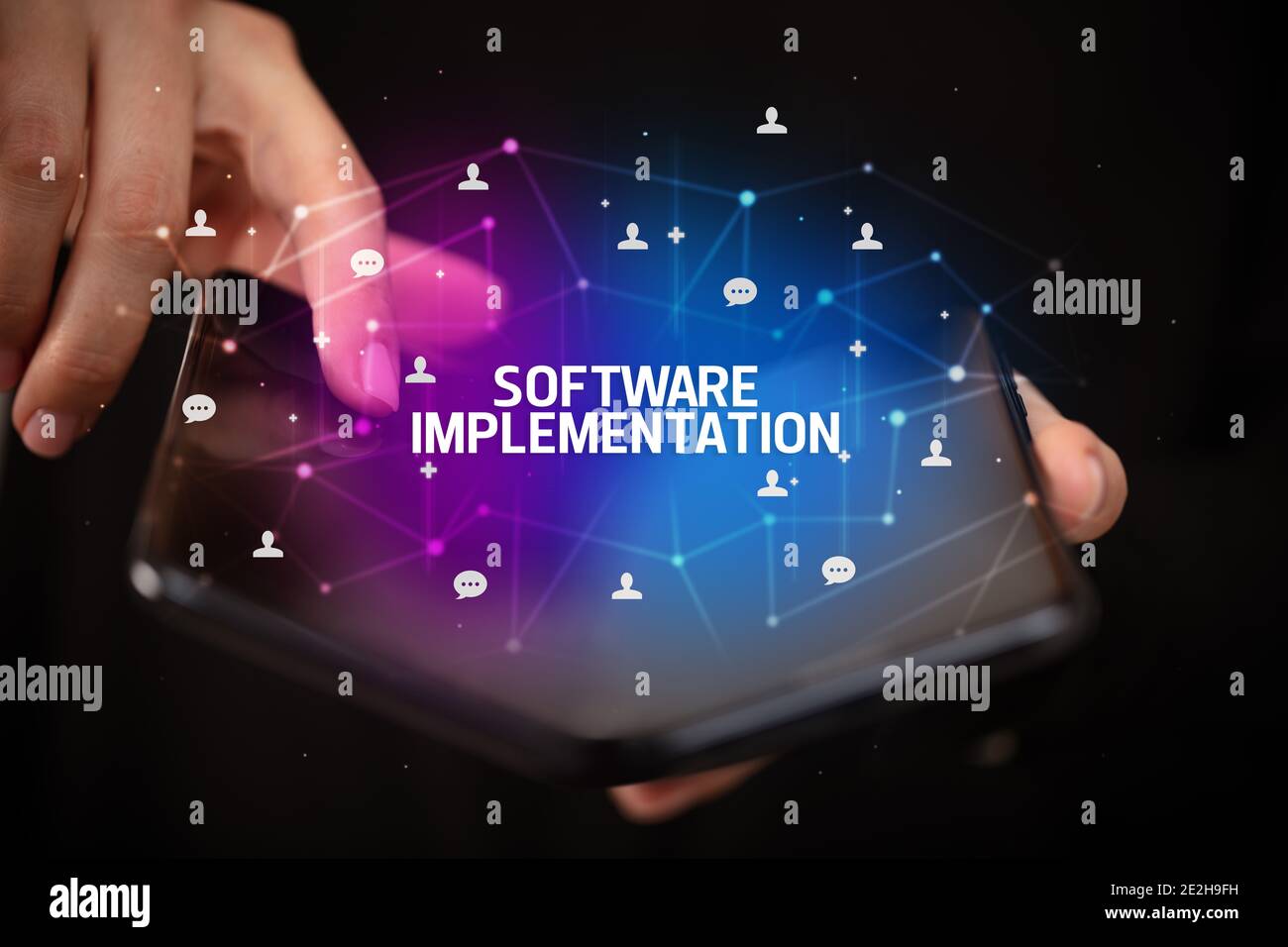 Inscription Technology Businessman holding a foldable smartphone with SOFTWARE IMPLEMENTATION ...
