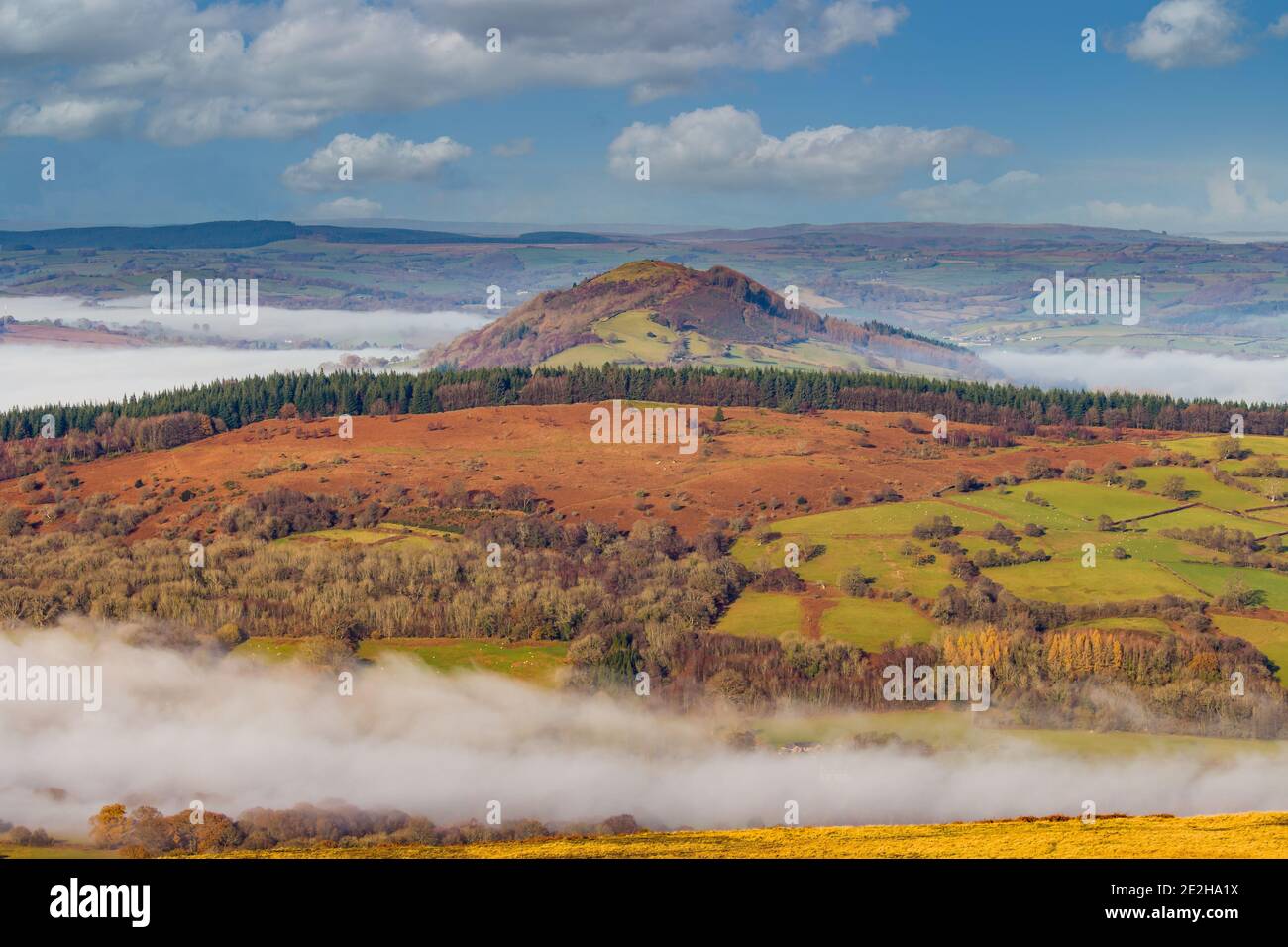 A fog filled rural valley surrounded by hills and fields (Allt yr Esgair, Wales) Stock Photo
