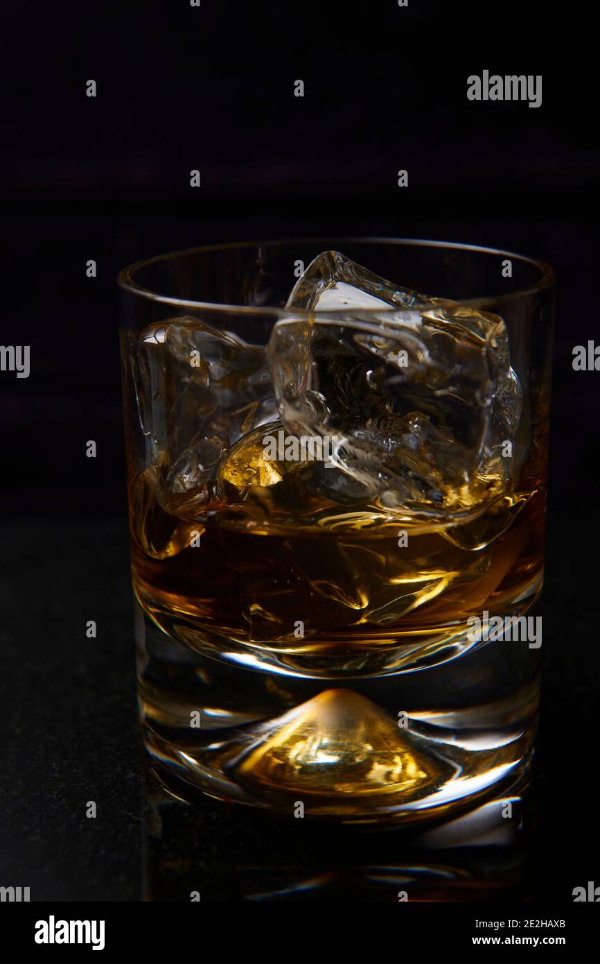 Whisky and ice in a plain whisky glass Stock Photo Alamy