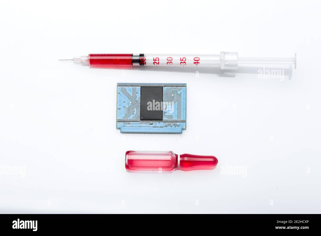 glass ampoule and syringe with a needle with a red vaccine and a microchip for vaccination and total control, objects isolated on a white background, Stock Photo