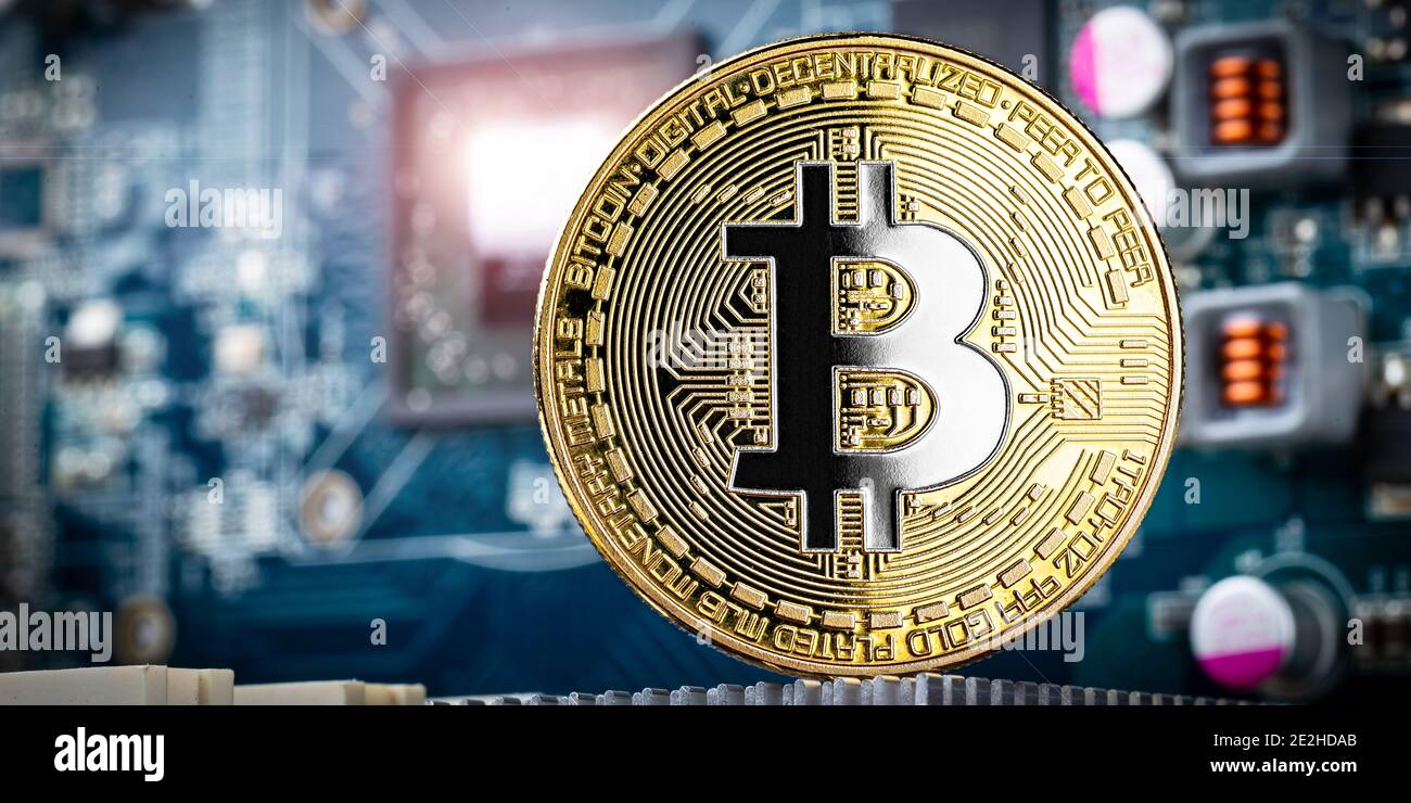 gold silver bitcoin crypto currency coin in front of high technology computer mining gpu hardware. Business digital financial concept Stock Photo