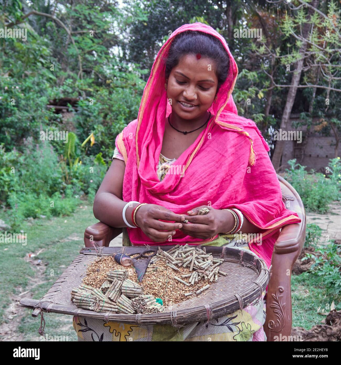 bengali tobacco Baranagar village. West Bengal, India. A woman making local cigarettes in  the street. Tobacco wholesalers distribute in the villages the necessary  equ Stock Photo