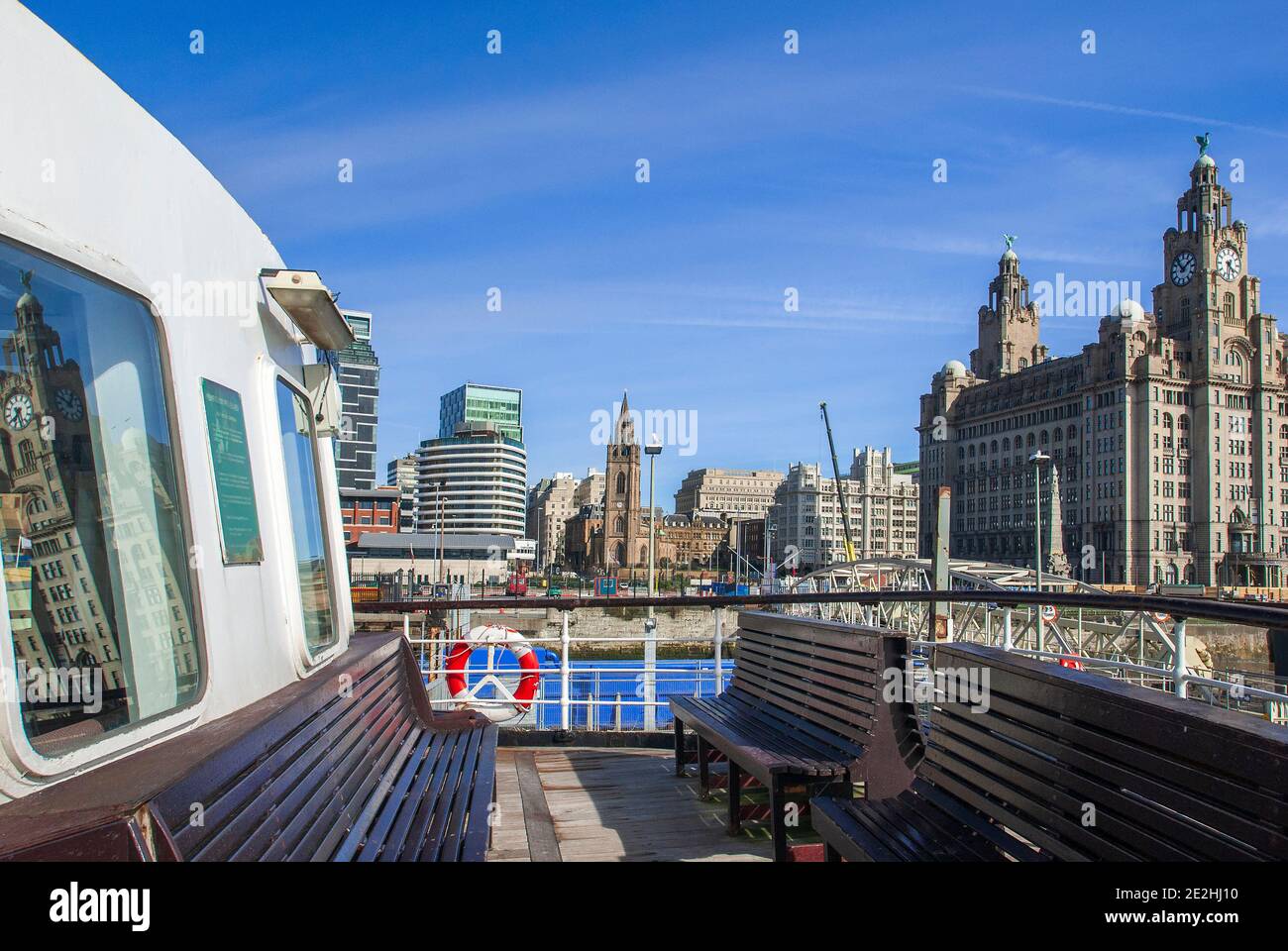 A Mersey ferry pictured berthed at the Liverpool Pier Head with the Parish church of St. Nicholas and the Royal Liver building in the background. Stock Photo