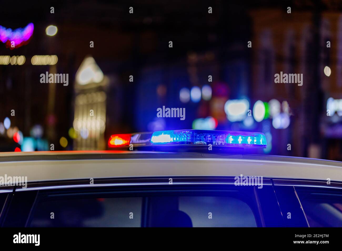 police car lights at night in city with selective focus and bokeh blur ...