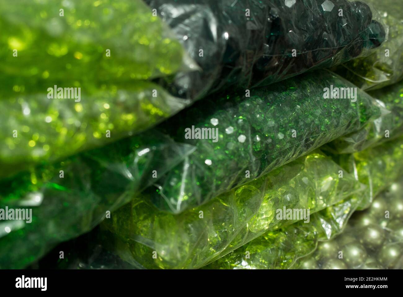 Stacks of green crystals and pearls packages for bijou Stock Photo