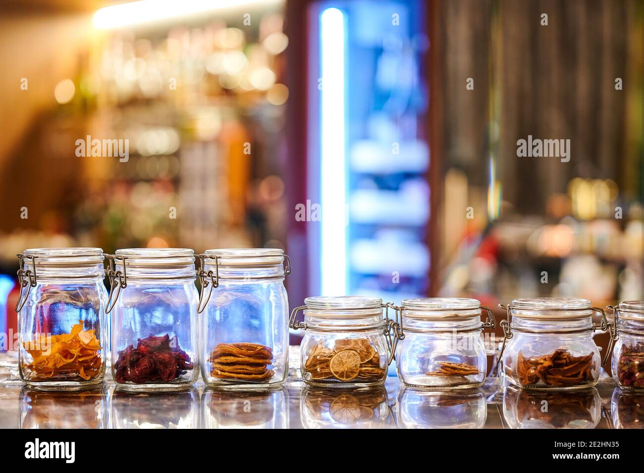 Glass jars and containers with dried fruit for cocktails in a